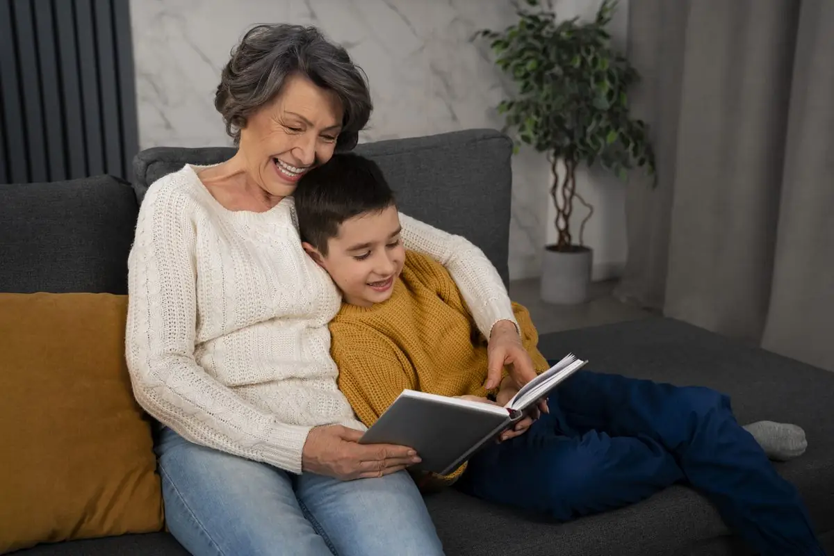 A grandparent reading a book with a grandchild