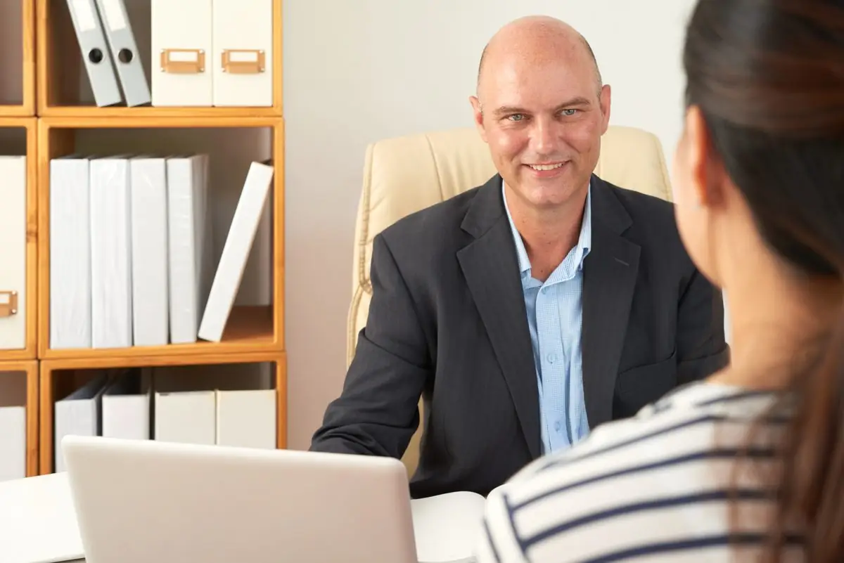 A family lawyer advising a parent about parenting arrangements in a bright office