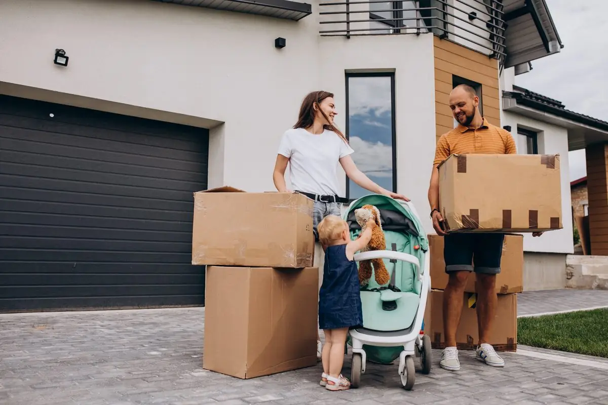 A family moving house with cardboard boxes at the door