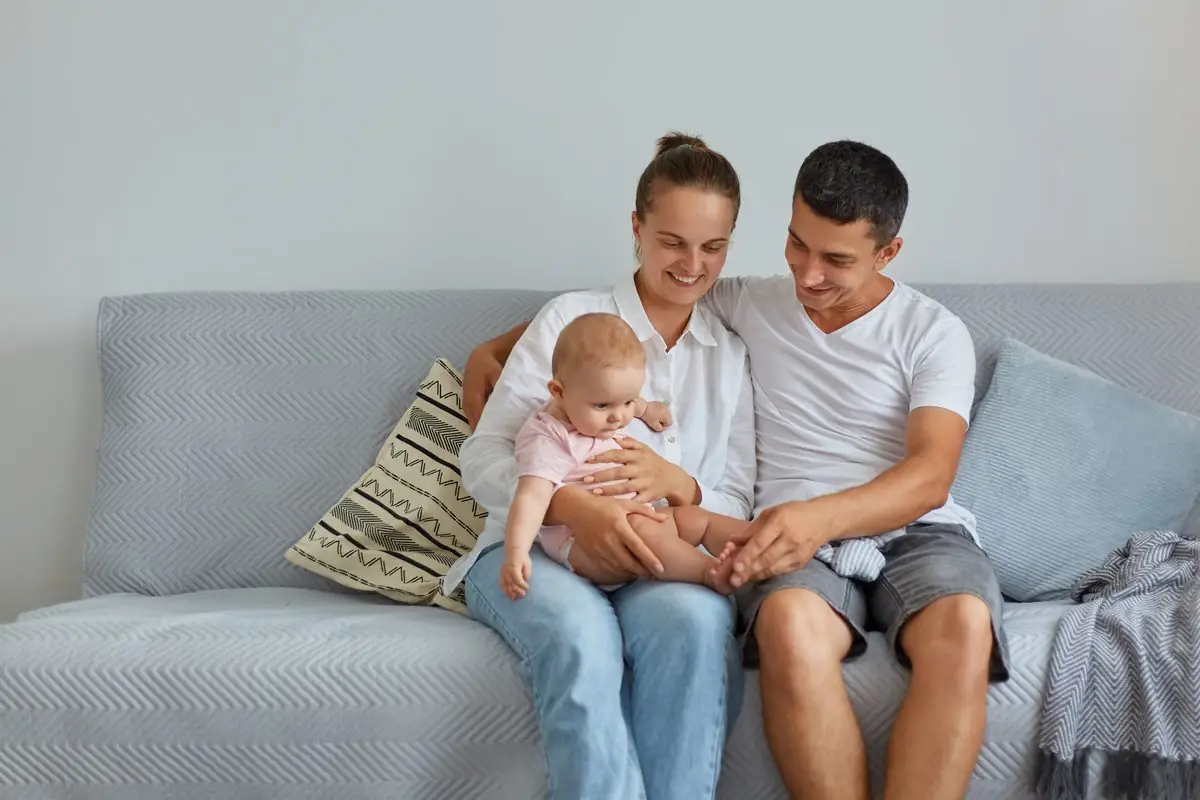 An unmarried couple at home with their young child