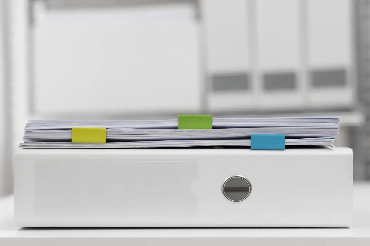 A neat stack of case files with coloured tabs marking each issue
