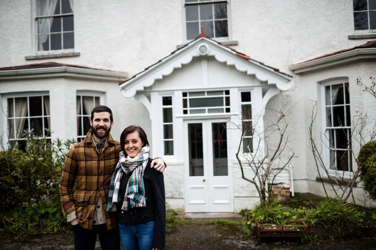 A couple standing together in front of their house, the residence that decides which province can hear a divorce