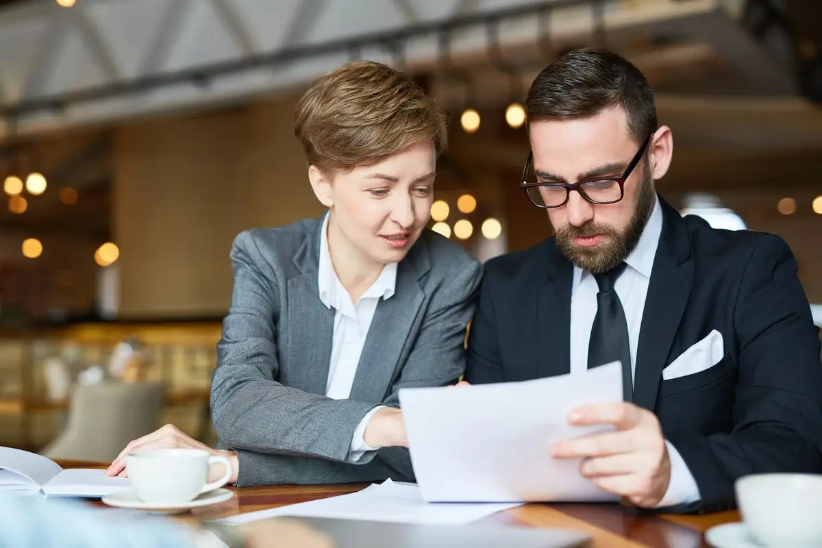 Two professionals discussing the terms of an agreement across a table