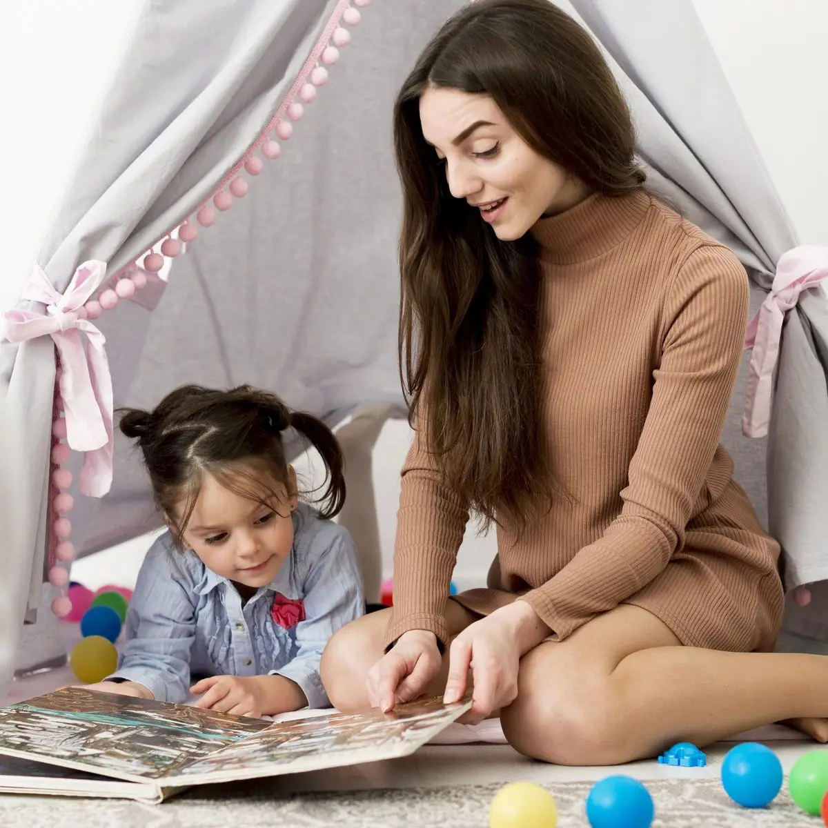 A parent and young child looking at a picture book together