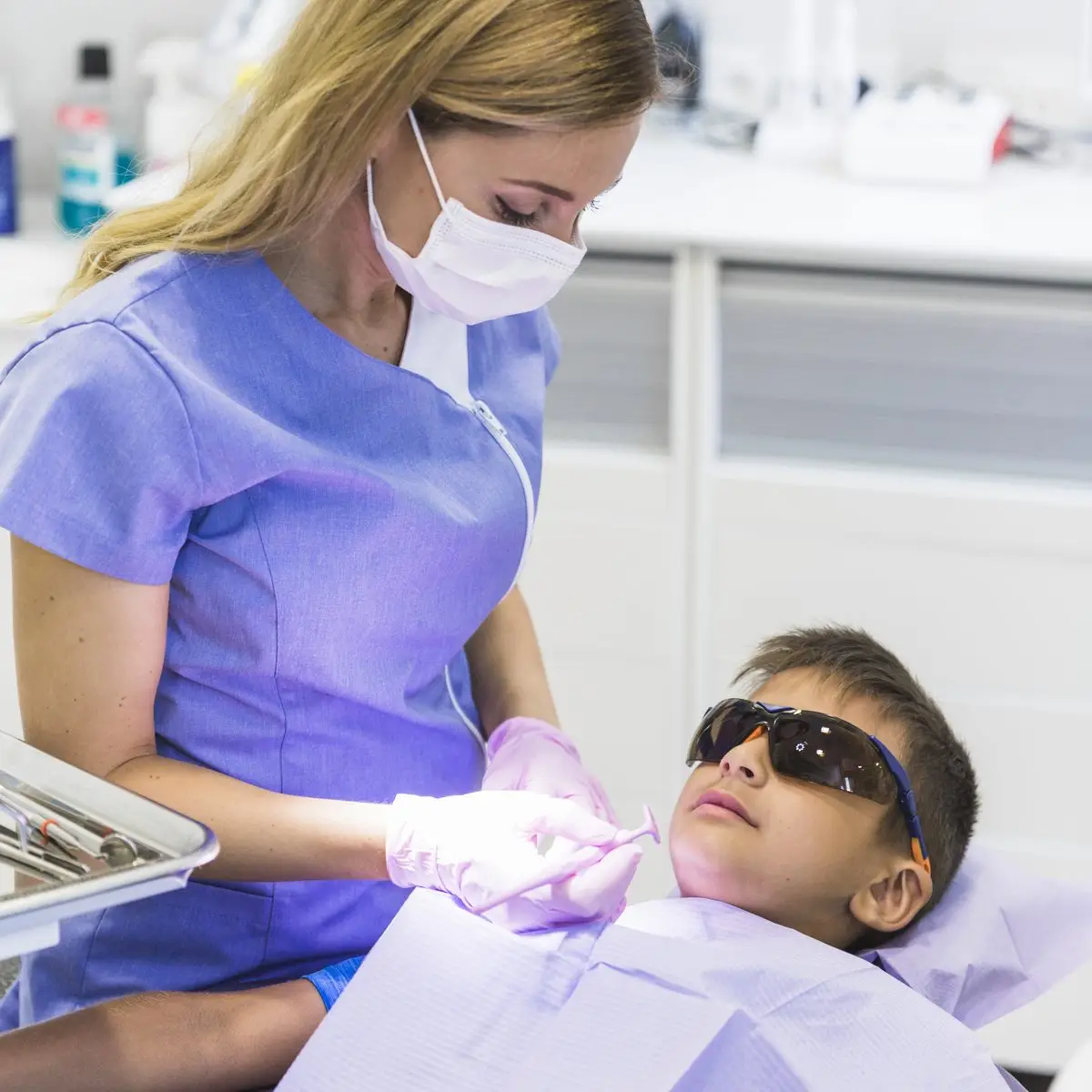 A dentist examining the teeth of a young patient