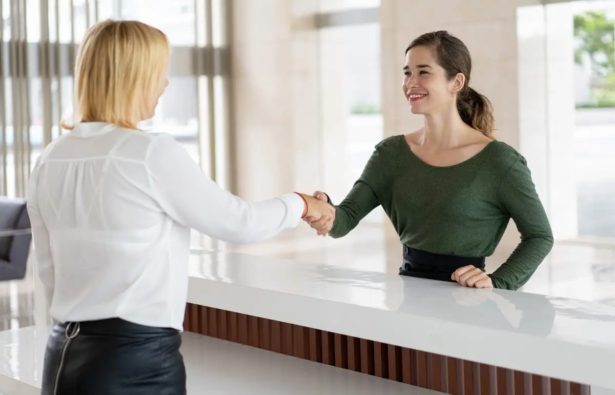 Two people shaking hands to confirm an agreement