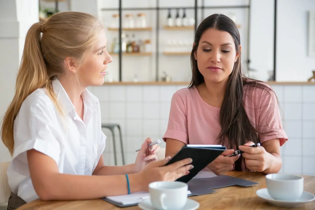 A client and an adviser going through a paper together at a table