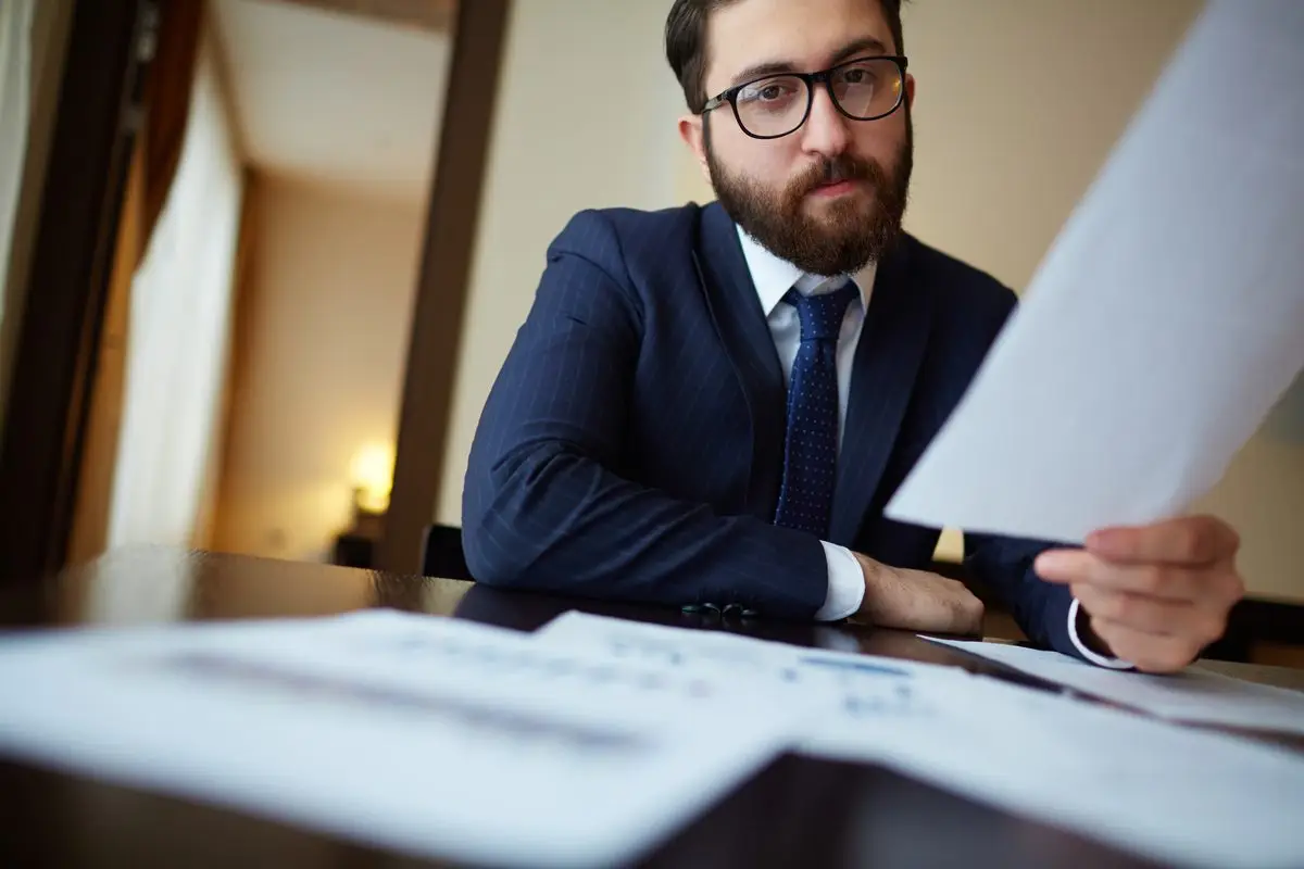 A man reading a document at a desk