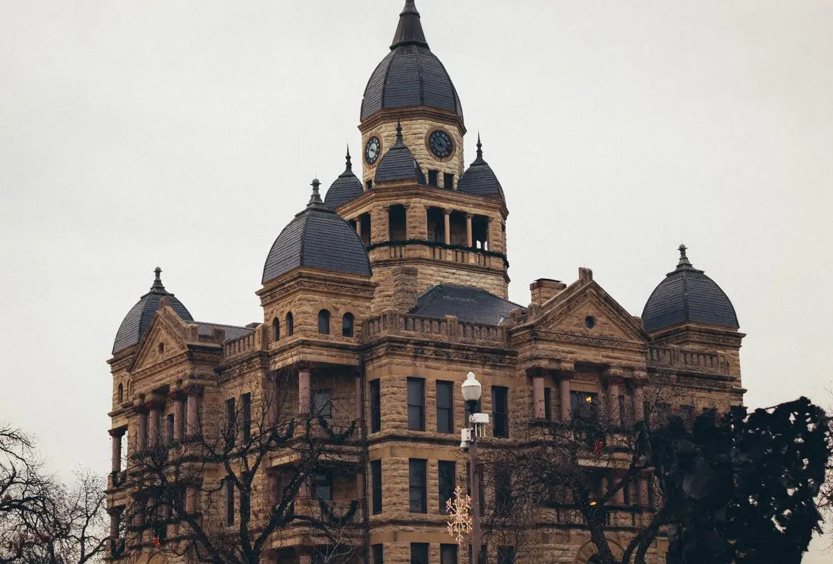 A historic courthouse building with towers and a clock