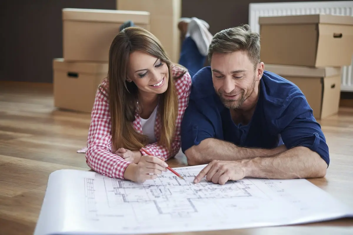 An unmarried couple planning their shared home together among moving boxes
