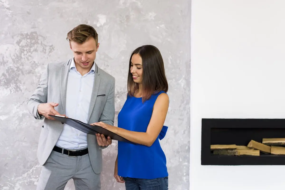 Two colleagues going through a clipboard list of assets together