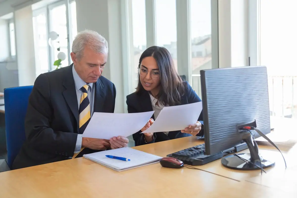 A family lawyer going through documents with a client at a desk