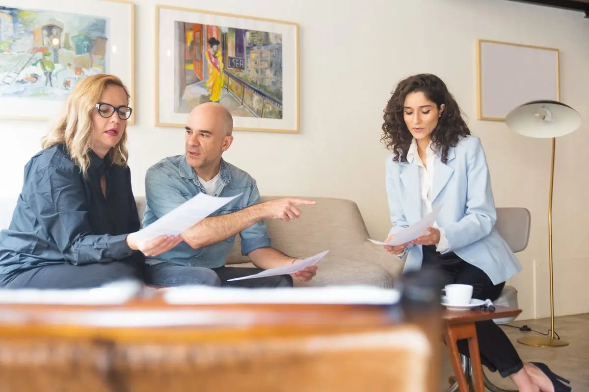 A couple talking through documents with a legal adviser