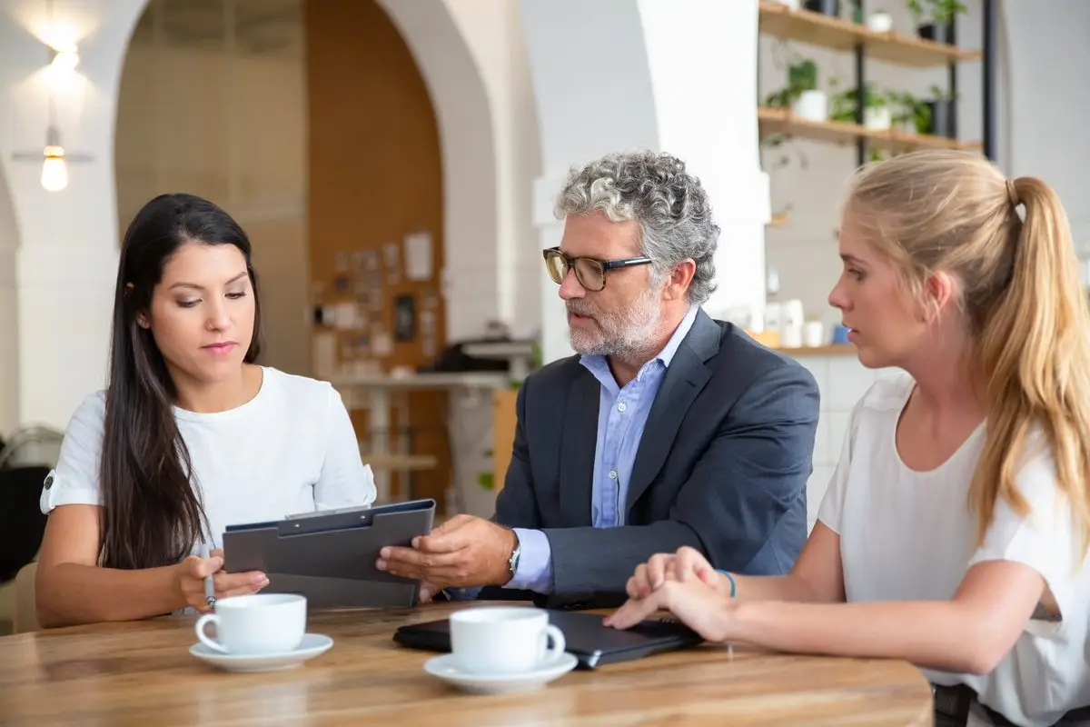 A professional explaining the terms of an agreement to a couple