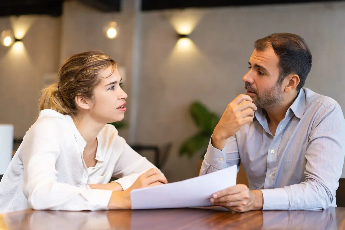 A lawyer and a client going through a document together to check which route applies